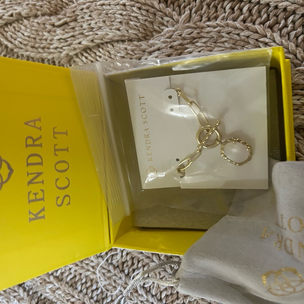 Kendra Scott gold necklace.